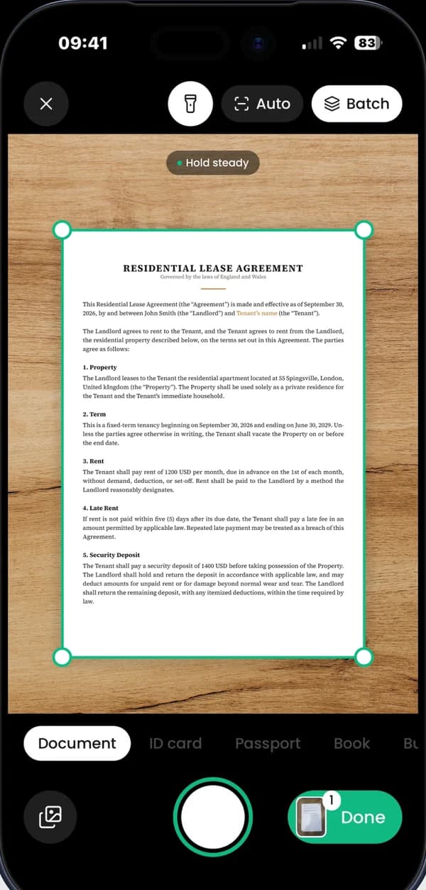 App Store screenshot: It's easy, it's done. The scanner finding the edges of a lease agreement on a wooden desk.